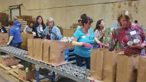 Volunteers pack emergency food bags